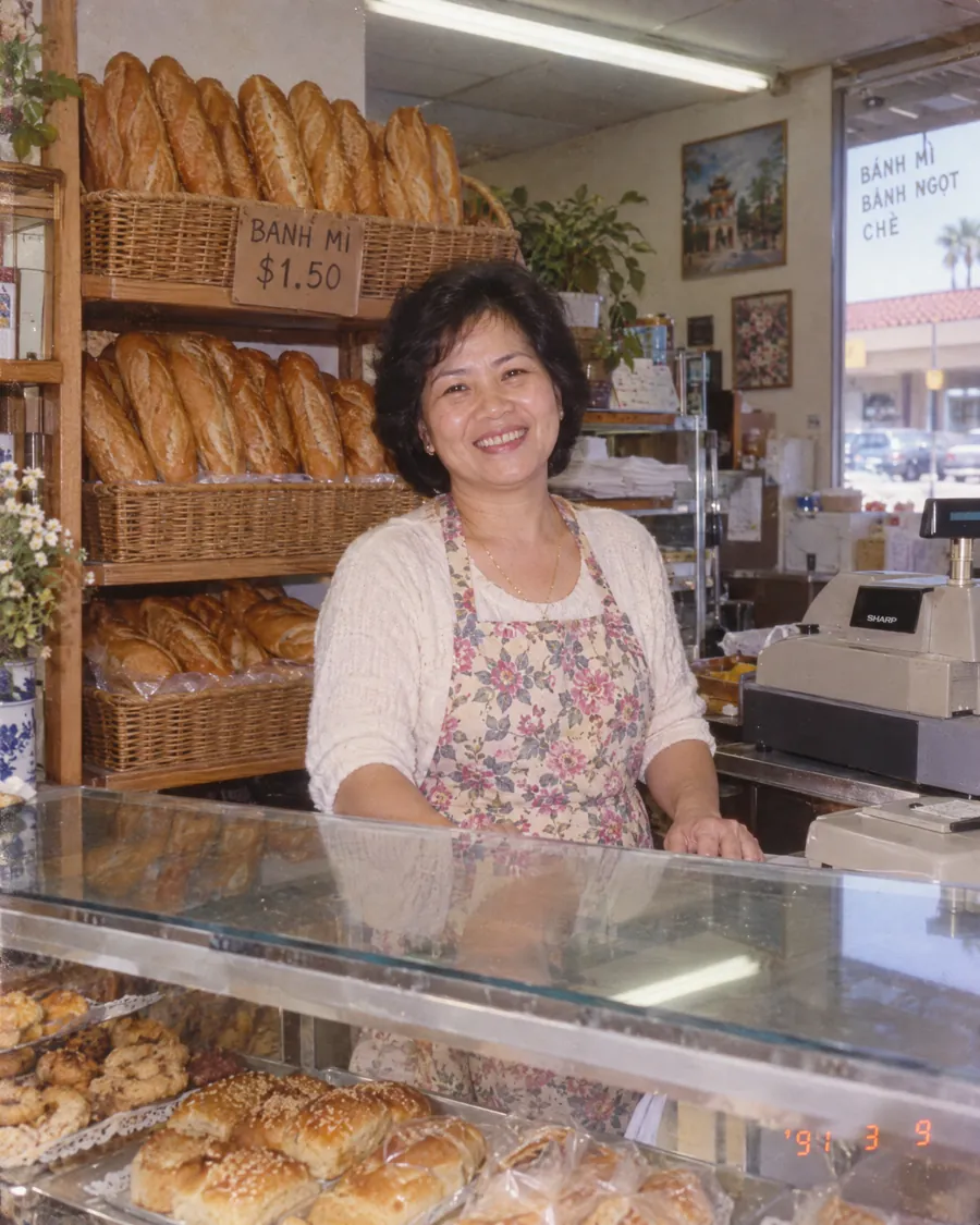 Bà Năm behind the counter of her first bakery in 1991