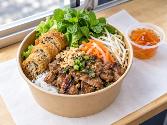 A bowl of bún thịt nướng with a crispy roll and herbs