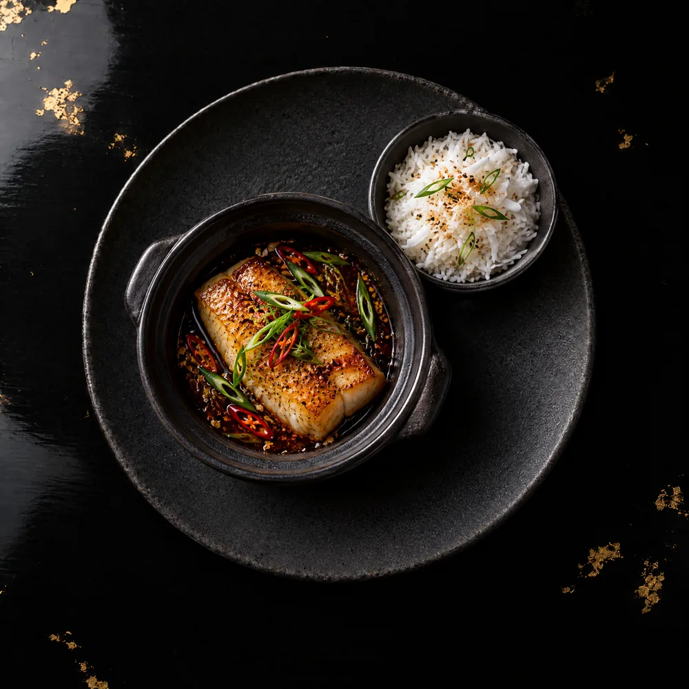 Cá kho tộ — Chilean sea bass, clay-pot caramel, black pepper, coconut rice